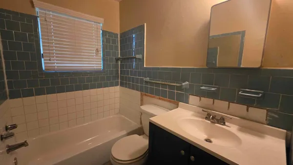 a bathroom with a sink a toilet and bathtub