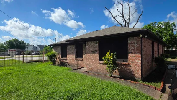 a view of a house with backyard porch and sitting area
