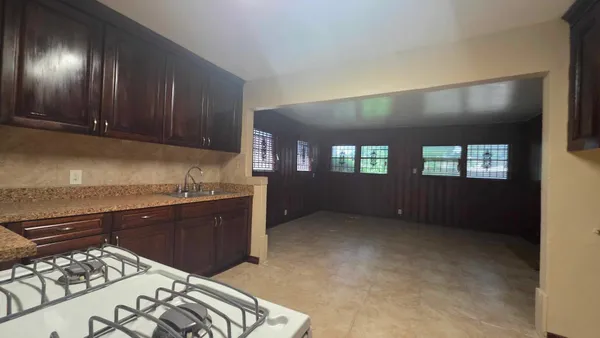 a kitchen with stainless steel appliances granite countertop a stove a sink and a refrigerator