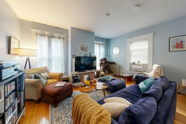 a kitchen with stainless steel appliances granite countertop a sink cabinets and wooden floor