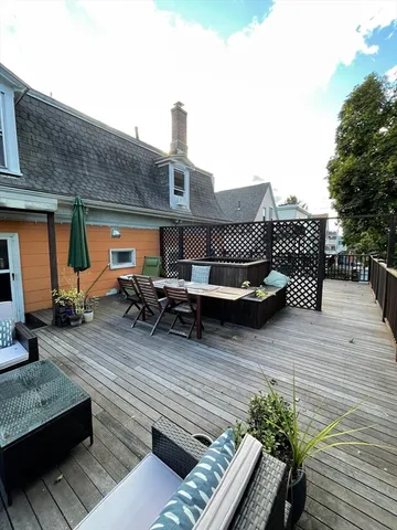 a living room with furniture a rug and a window
