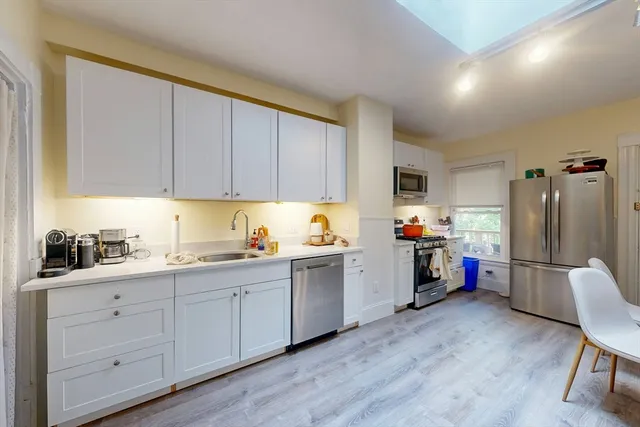a bed room with a bed and a chandelier