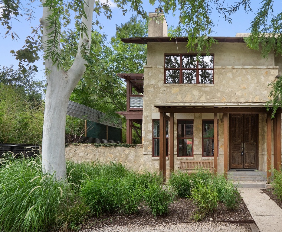 an entrance to house with yard and green space