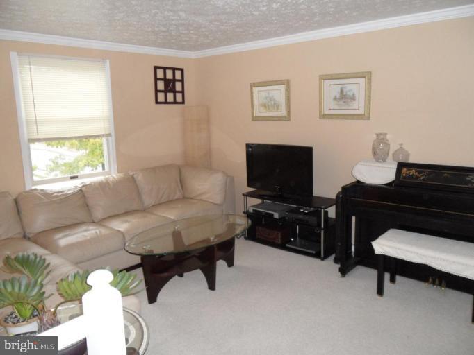 5057 Clifford Road Perry Hall, MD 21128 - Photo 2 of 13 a living room with furniture and a flat screen tv