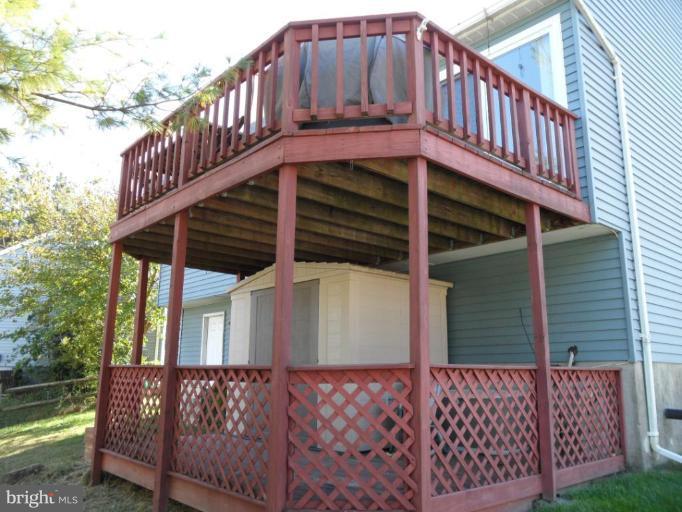5057 Clifford Road Perry Hall, MD 21128 - Photo 11 of 13 a view of a house with a wooden deck