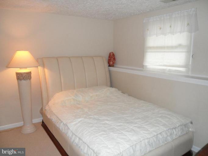 5057 Clifford Road Perry Hall, MD 21128 - Photo 5 of 13 a bedroom with a bed and a window