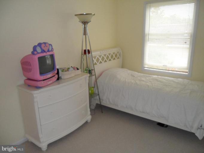 5057 Clifford Road Perry Hall, MD 21128 - Photo 7 of 13 a bedroom with a bed and a window