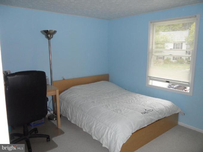 5057 Clifford Road Perry Hall, MD 21128 - Photo 8 of 13 a bedroom with a bed and a window