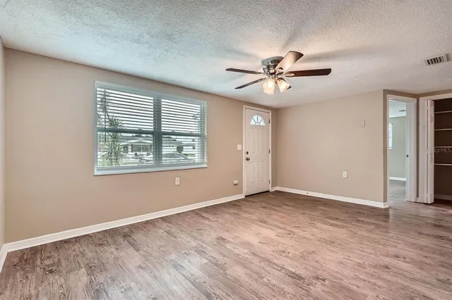 wooden floor in an empty room with a window