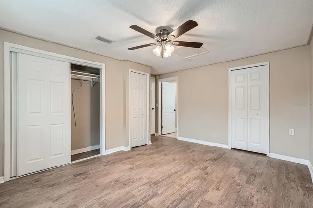 a view of an empty room with a ceiling fan