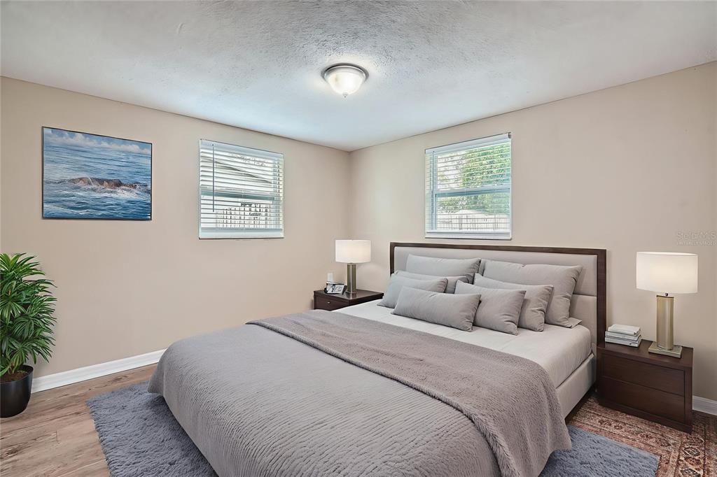 5429 Flora Avenue Holiday, FL 34690 - Photo 21 of 33 a bedroom with a large bed and a potted plant