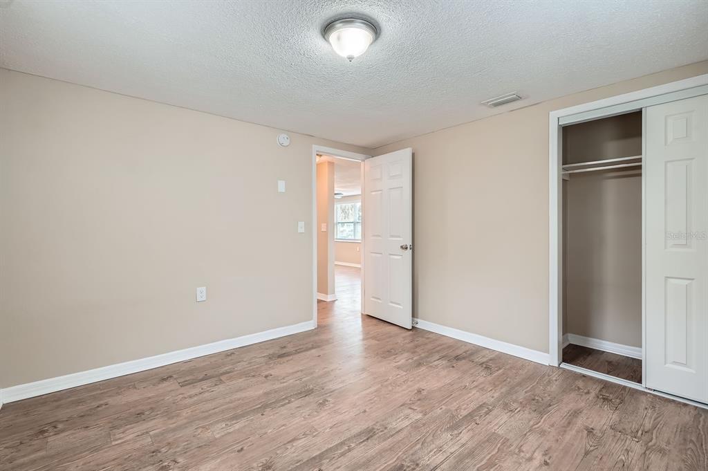 5429 Flora Avenue Holiday, FL 34690 - Photo 23 of 33 a view of an empty room with wooden floor and a window