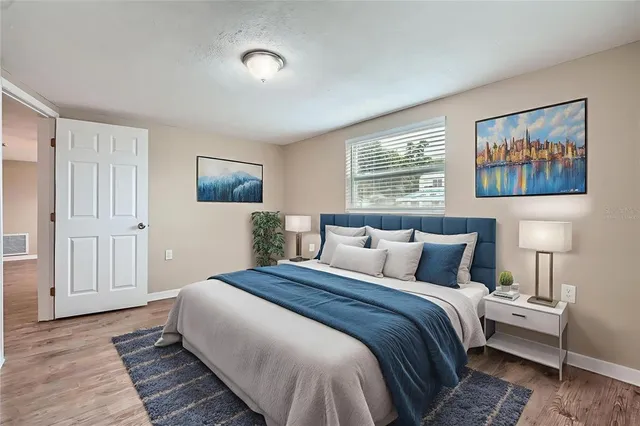 a bedroom with bed and night stand