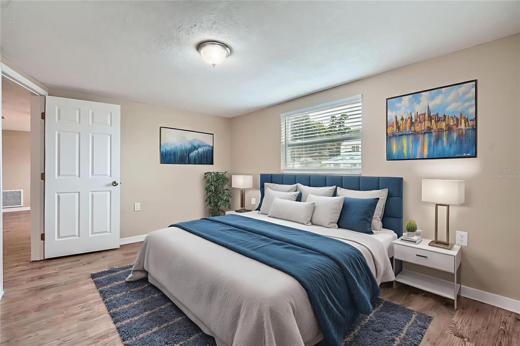 5429 Flora Avenue Holiday, FL 34690 - Photo 25 of 33 a bedroom with bed and night stand