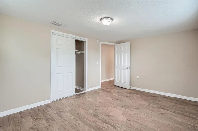 a view of an empty room and wooden floor