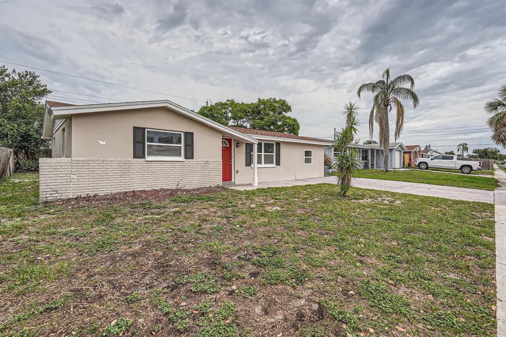 5429 Flora Avenue Holiday, FL 34690 - Photo 33 of 33 a house view with a garden space