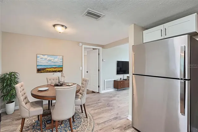 a dining room with furniture a refrigerator and a table