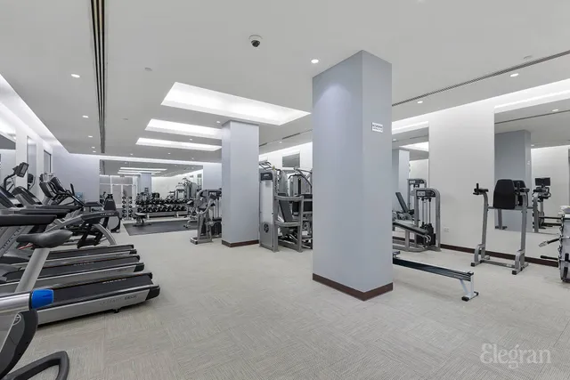 a front view of a residential apartment building with a yard