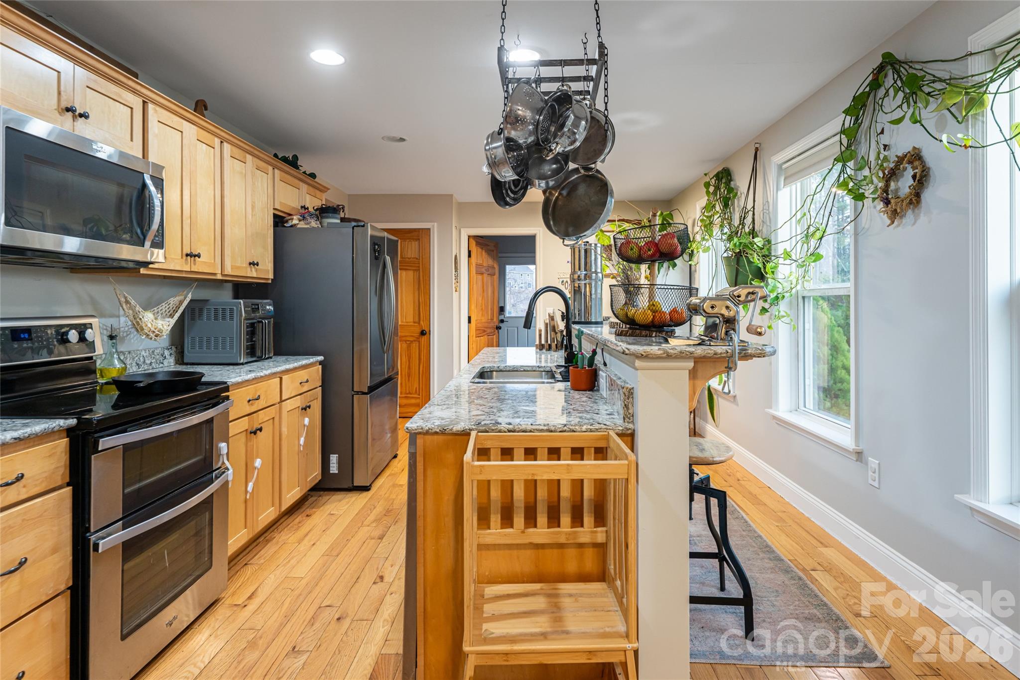 65 Owenby Road Candler, NC 28715 - Photo 23 of 48 a kitchen with stainless steel appliances granite countertop a sink a stove and a wooden cabinets