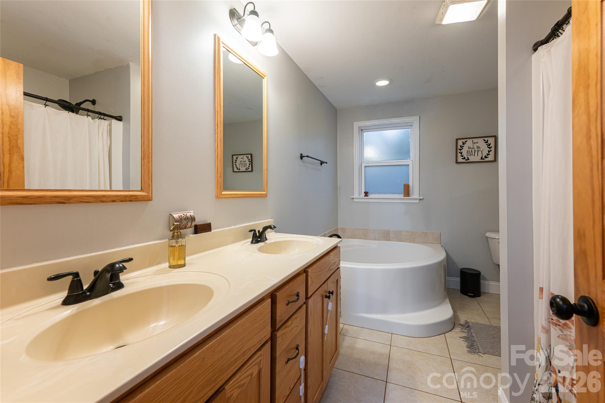 65 Owenby Road Candler, NC 28715 - Photo 27 of 48 a bathroom with a sink double vanity granite and a toilet