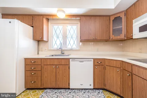 a kitchen with sink cabinets and window