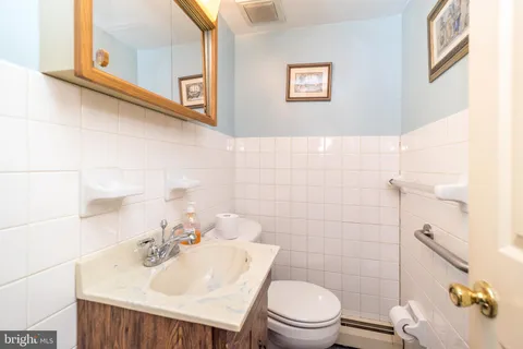 a bathroom with a sink mirror and toilet