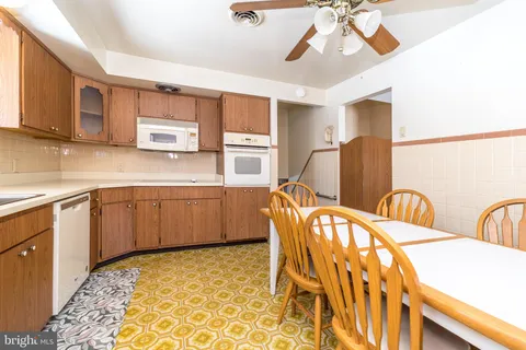 a kitchen with stainless steel appliances kitchen island granite countertop a sink and cabinets