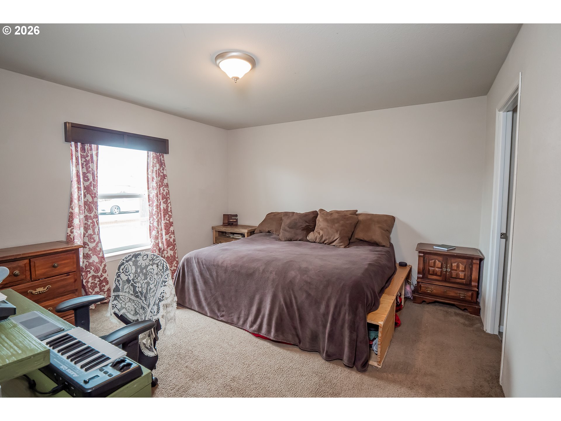 628 Stanley Lane Harrisburg, OR 97446 - Photo 13 of 32 a bedroom with a bed and wooden floor