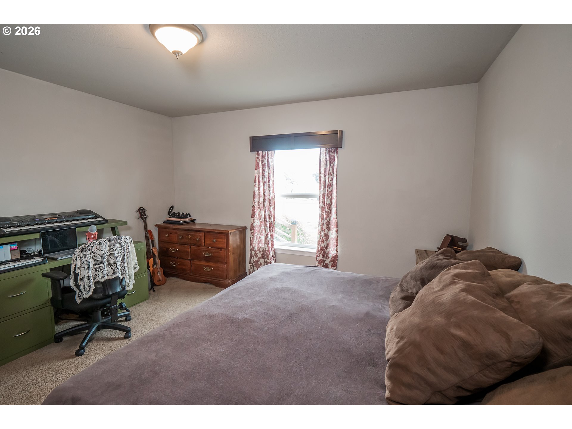 628 Stanley Lane Harrisburg, OR 97446 - Photo 15 of 32 a bed sitting in a bedroom next to a window
