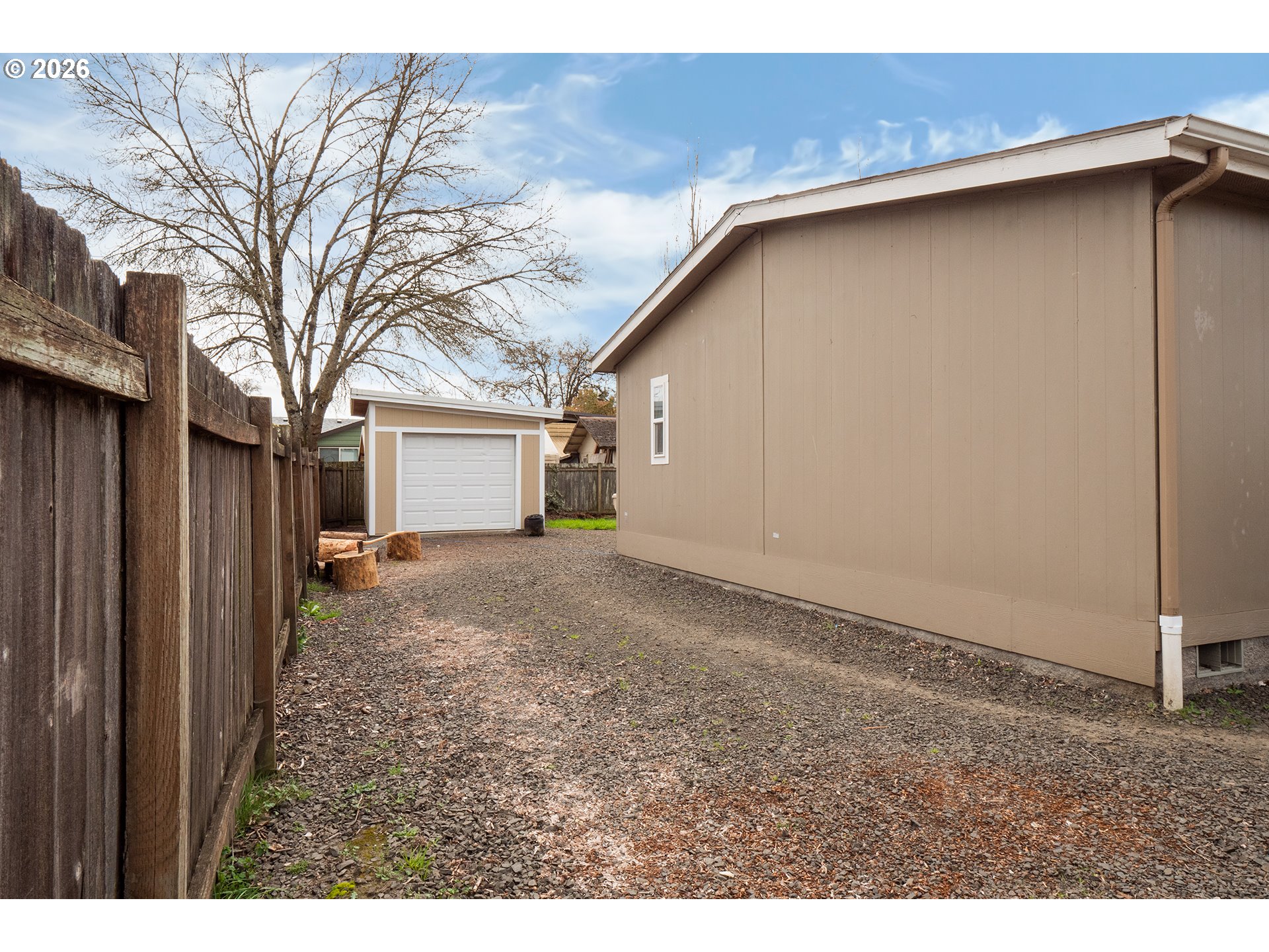 628 Stanley Lane Harrisburg, OR 97446 - Photo 24 of 32 a view of a house with a backyard and garage