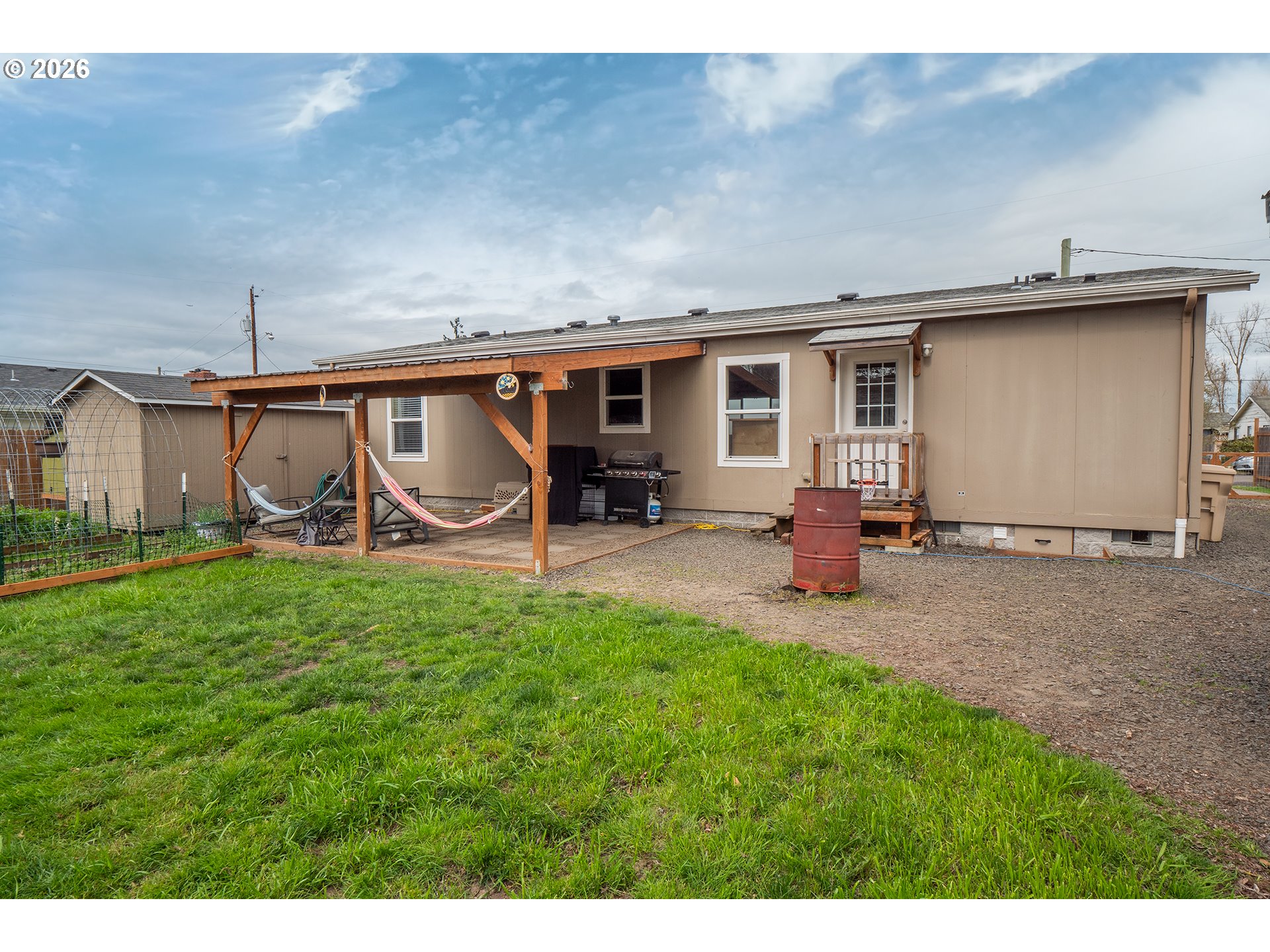 628 Stanley Lane Harrisburg, OR 97446 - Photo 25 of 32 a view of a backyard with table and chairs