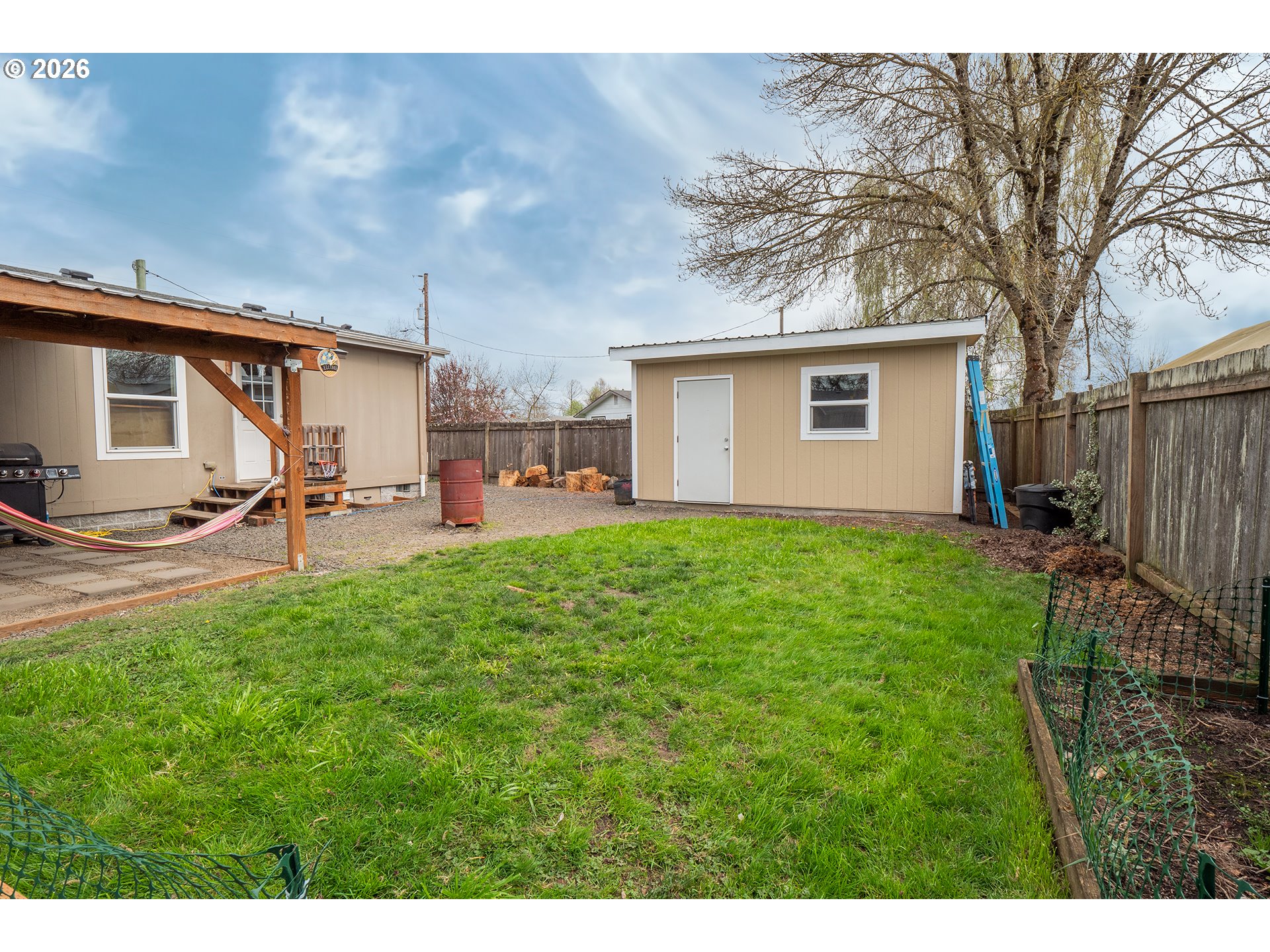 628 Stanley Lane Harrisburg, OR 97446 - Photo 28 of 32 a backyard of a house with table and chairs