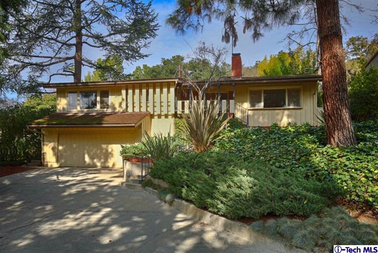 a view of a house with a yard next to a lake