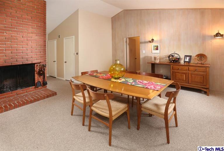 1011 Hillside Terrace Pasadena, CA 91105 - Photo 11 of 32 a dining room with furniture and a fireplace