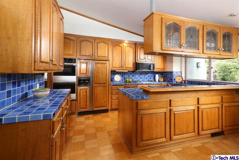 1011 Hillside Terrace Pasadena, CA 91105 - Photo 12 of 32 a kitchen with stainless steel appliances granite countertop a stove a sink and dishwasher cabinets with wooden floor