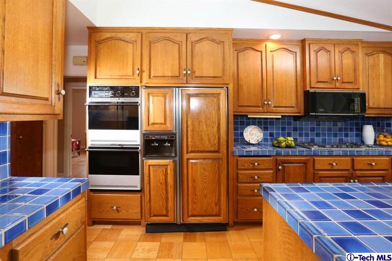 1011 Hillside Terrace Pasadena, CA 91105 - Photo 13 of 32 a kitchen with stainless steel appliances granite countertop a refrigerator a stove and a microwave