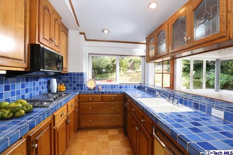1011 Hillside Terrace Pasadena, CA 91105 - Photo 14 of 32 a kitchen with stainless steel appliances granite countertop a sink a stove and a microwave