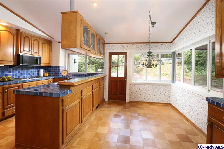 1011 Hillside Terrace Pasadena, CA 91105 - Photo 15 of 32 a kitchen with stainless steel appliances granite countertop a stove a sink dishwasher and a refrigerator