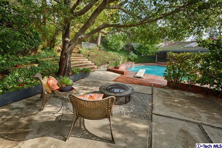 1011 Hillside Terrace Pasadena, CA 91105 - Photo 26 of 32 a backyard of a house with table and chairs under an umbrella