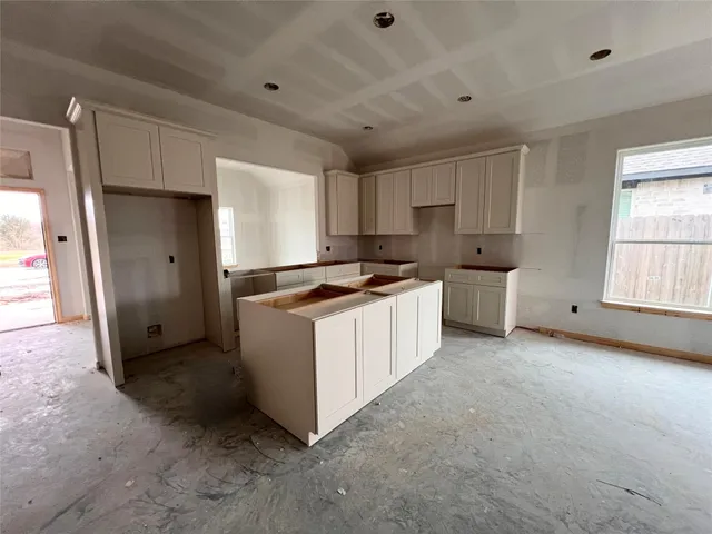 a kitchen with white cabinets and white appliances