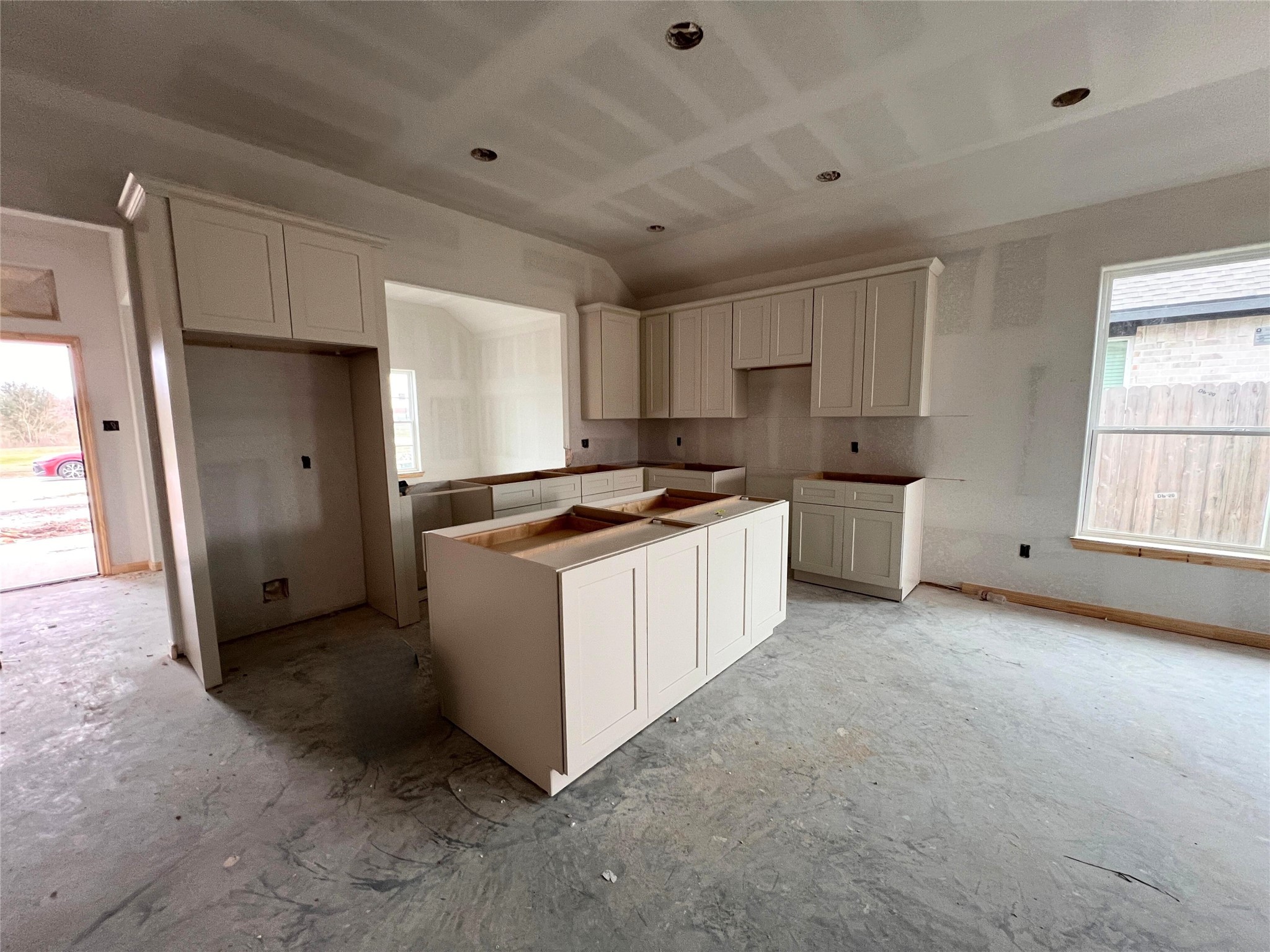 a kitchen with white cabinets and white appliances