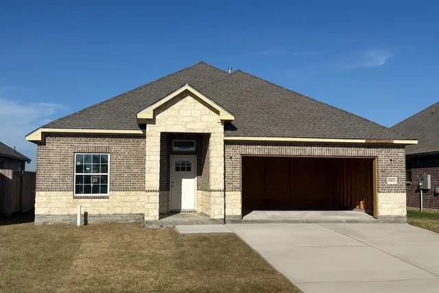 a front view of a house with a garage