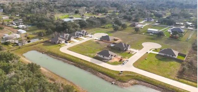an aerial view of a house with a lake view