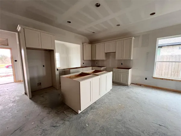a kitchen with white cabinets and white appliances