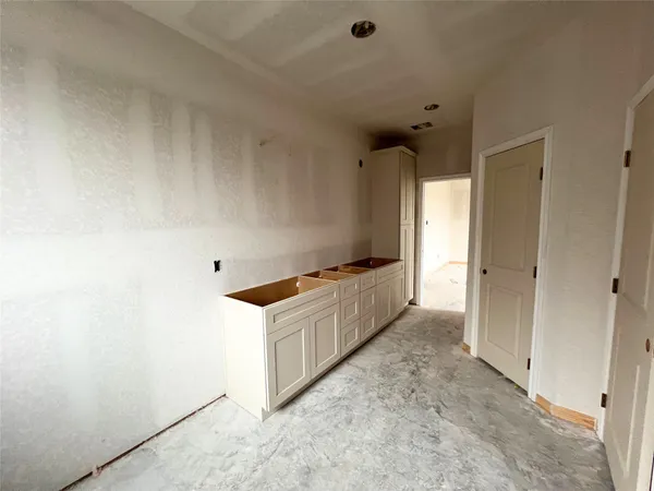 a kitchen with granite countertop a stove and a refrigerator