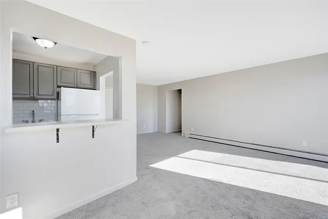 a view of kitchen with kitchen island and stainless steel appliances