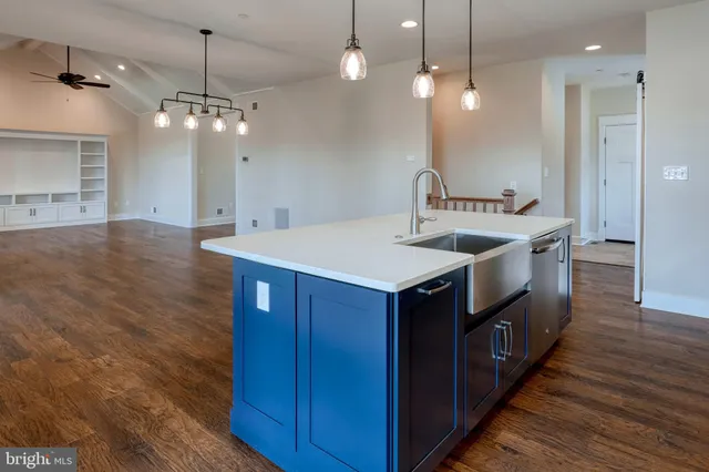 a kitchen with stainless steel appliances granite countertop a sink a stove and a refrigerator