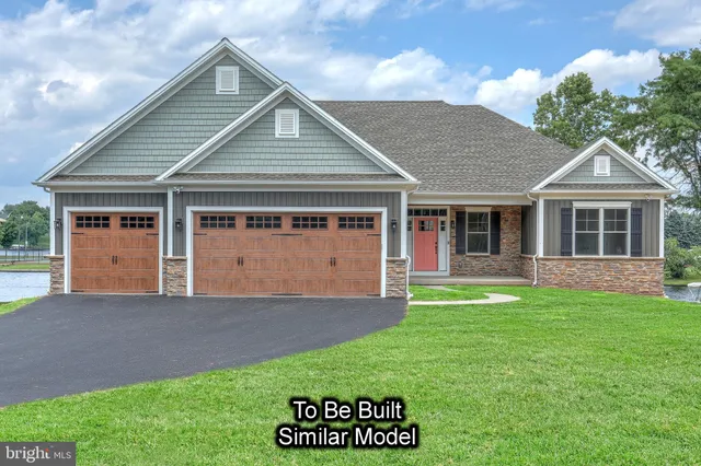 a front view of house with yard outdoor seating and green space