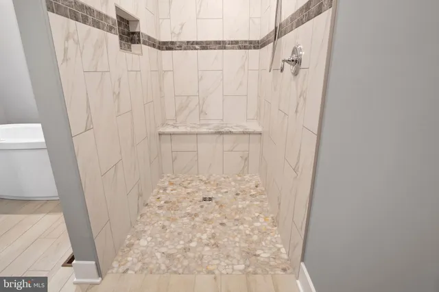 a view of a room with wooden floor and windows