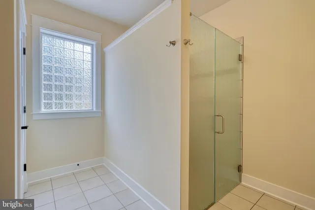 a view of a room with wooden floor and ceiling fan